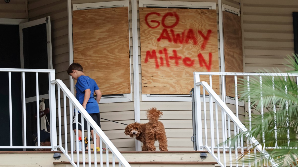 Noah Weibel and his dog Cookie climb the steps to their home as their family prepares for Hurricane Milton on Monday, October 7, 2024, in Port Richey, Florida. AP Noah Weibel and his dog Cookie climb the steps to their home as their family prepares for Hurricane Milton on Monday, October 7, 2024, in Port Richey, Florida. AP