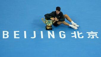 Carlos Alcaraz poses with the winner's trophy after being crowned China Open men's singles champion at the National Tennis Center in Beijing, China. AP