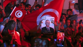 Supporters of Tunisian President and candidate for re-election Kais Saied celebrate after announcement of provisional results of presidential elections. AP