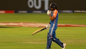 India captain Harmanpreet Kaur walks back after being dismissed for 15 by Rosemary Mair. AP 