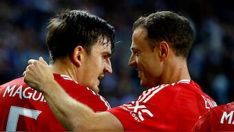 Harry Maguire celebrates with Jonny Evans after securing a draw for Man United vs Porto. Image: Reuters