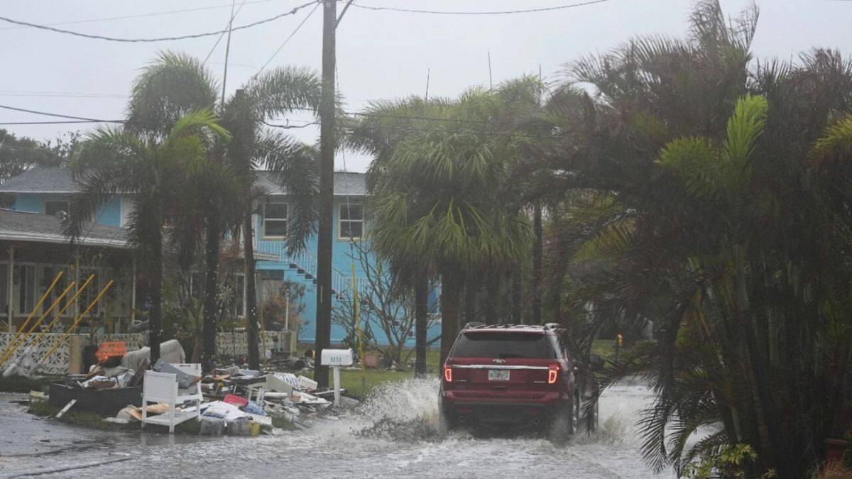 A car drives past a pile of debris from Hurricane Helene flooding, along a street that had already begun flooding from rain ahead of the arrival of Hurricane Milton, in Gulfport, Fla., Wednesday, October 9, 2024. Source: AP. A car drives past a pile of debris from Hurricane Helene flooding, along a street that had already begun flooding from rain ahead of the arrival of Hurricane Milton, in Gulfport, Fla., Wednesday, October 9, 2024. Source: AP.