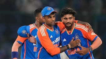 Captain Suryakumar Yadav, Nitish Reddy (right) and Hardik Pandya (background, face covered) celebrate India's 86-run victory over Bangladesh in the second T20I in Delhi on Wednesday, 10 October. AP