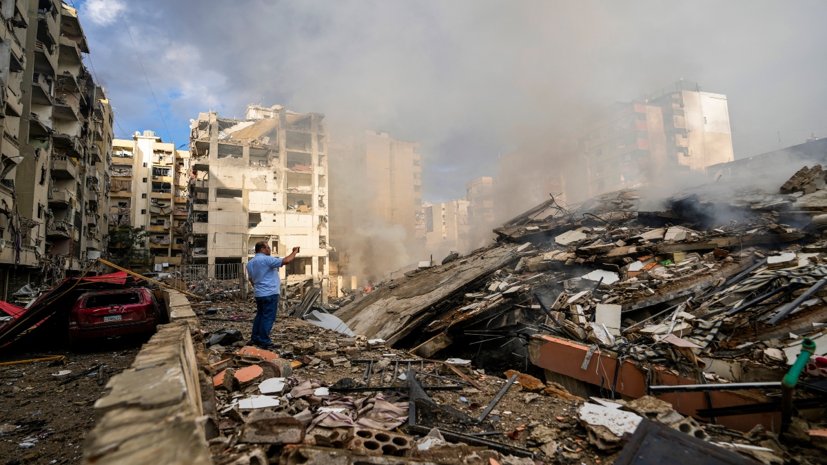 A man documents the damaged buildings at the site of an Israeli airstrike in Beirut's southern suburb, Lebanon, on Tuesday. AP A man documents the damaged buildings at the site of an Israeli airstrike in Beirut's southern suburb, Lebanon, on Tuesday. AP