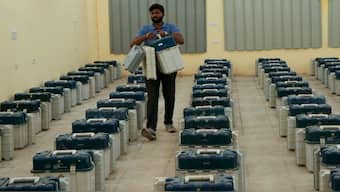 A polling official carries electronic voting machines and other election material for distribution on the eve of the third phase of the Jammu and Kashmir Assembly election, in Jammu, on Monday. AP 