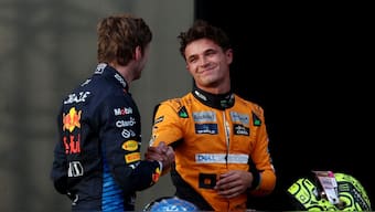 McLaren's Lando Norris celebrates after qualifying in pole position with second placed Red Bull's Max Verstappen. Reuters