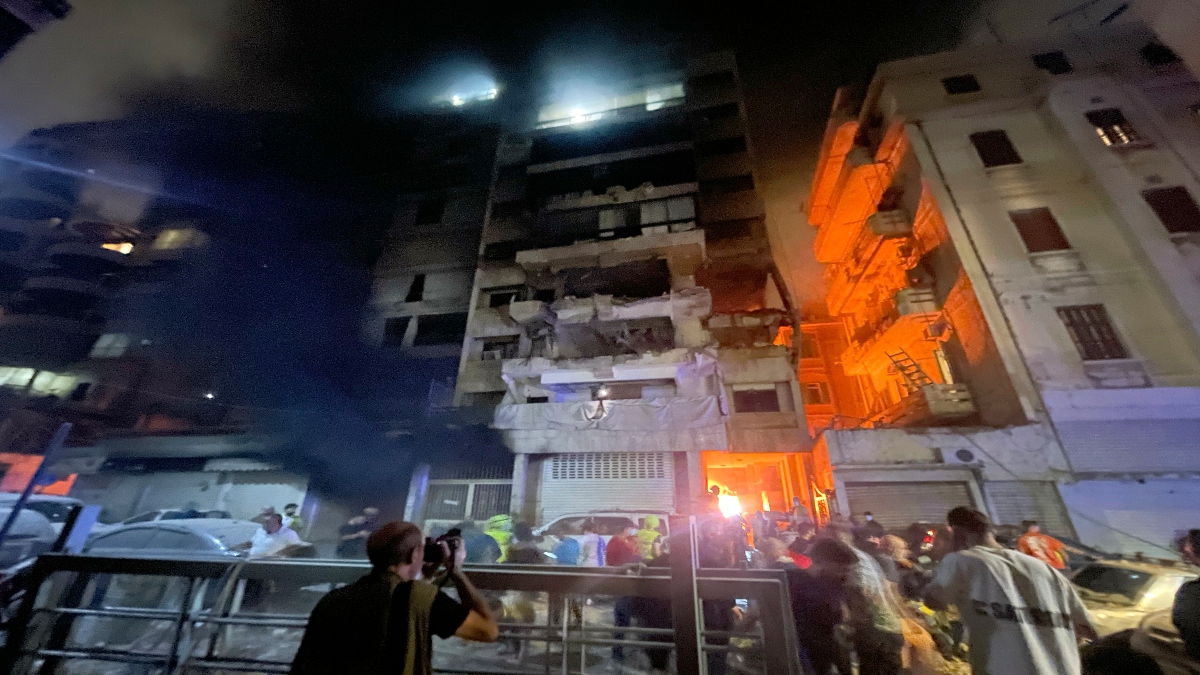 People gather in front a destroyed building hit by an Israeli airstrike in central Beirut, Lebanon, on Thursday. AP People gather in front a destroyed building hit by an Israeli airstrike in central Beirut, Lebanon, on Thursday. AP