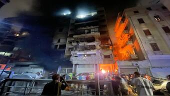 People gather in front a destroyed building hit by an Israeli airstrike in central Beirut, Lebanon, on Thursday. AP 