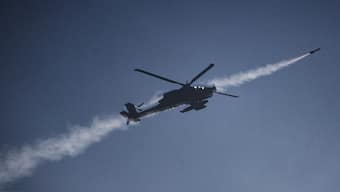 An Israeli Apache helicopter fires a missile towards southern Lebanon as seen from northern Israel, on Sunday. AP 