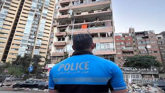 A Lebanese policeman looks at damaged apartments that were hit by Israeli strike early on Monday, in Beirut, Lebanon. AP 