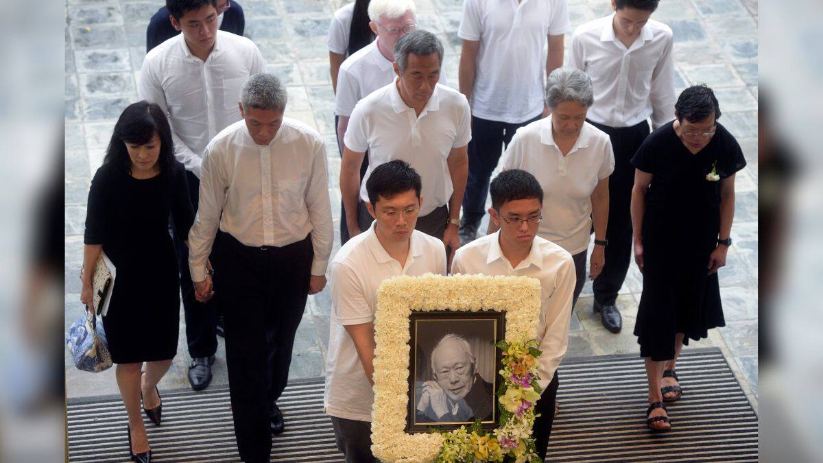Family members, second row left to right, Lee Suet Fern, son, (Lee Hsien Yang's wife), Lee Hsien Yang, Lee Hsien Loong, son and then prime minister, Ho Ching (Lee Hsien Loong's wife) and Lee Wei Ling, daughter, of the late Lee Kuan Yew arrive with his portrait at the start of the state funeral at the University Cultural Center in Singapore, March 29, 2015. File Image/AP