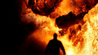 (File) A man is seen near thick smoke and fire at oil wells, which were set ablaze by Islamic State militants before they fled the oil-producing region of Qayyara, Iraq on January 28,2017. Reuters