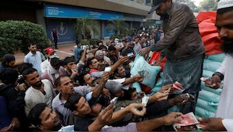 Men reach out to buy subsidised flour sacks from a truck in Karachi, Pakistan. Source: REUTERS | FILE.