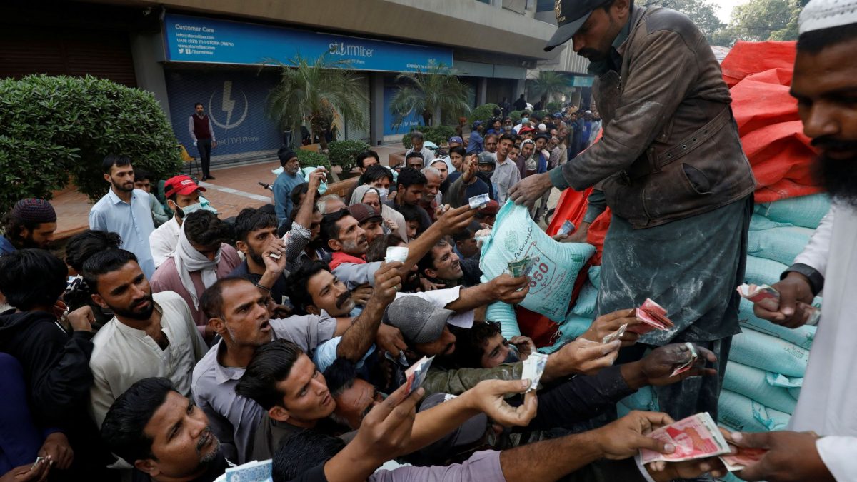Men reach out to buy subsidised flour sacks from a truck in Karachi, Pakistan. Source: REUTERS | FILE. Men reach out to buy subsidised flour sacks from a truck in Karachi, Pakistan. Source: REUTERS | FILE.