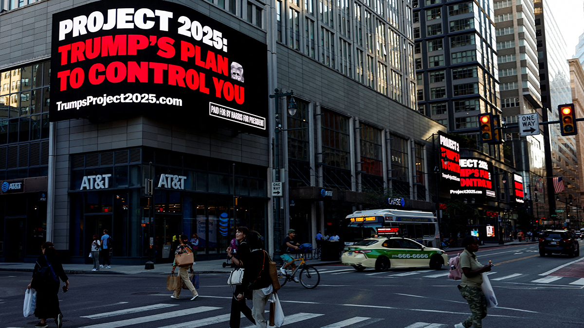 People walk as a digital billboard shows a slogan against Project 2025, ahead of the debate between Republican presidential nominee and former U.S. President Donald Trump and Democratic presidential nominee and US Vice President Kamala Harris, in Philadelphia, Pennsylvania, US, on September 10, 2024. Reuters People walk as a digital billboard shows a slogan against Project 2025, ahead of the debate between Republican presidential nominee and former U.S. President Donald Trump and Democratic presidential nominee and US Vice President Kamala Harris, in Philadelphia, Pennsylvania, US, on September 10, 2024. Reuters