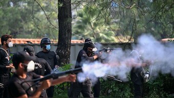 Policemen fire tear gas shells to disperse supporters of jailed former prime minister Imran Khan's Pakistan Tehreek-e-Insaf (PTI) party during a protest in Islamabad on October 5, 2024. -AFP
