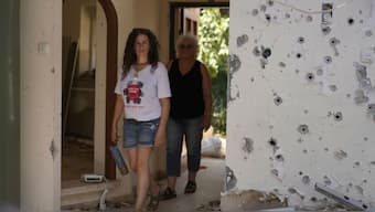 Liora Eilon, right, walks through her home that was destroyed by an Israeli tank on Oct. 7, with her daughter, Hadas Eilon-Carmi, left, in Kibbutz Kfar Aza, southern Israel, Sunday, Aug. 18, 2024.- Photo-AP