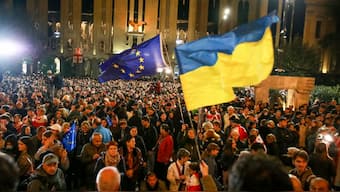 Demonstrators wave EU and Ukrainian national flags as they gather during an opposition protest against the results of the parliamentary election in Tbilisi, Georgia, Monday, Oct. 28, 2024. Image- AP