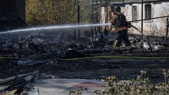 A firefighter puts out the fire after fragments of the downed Russian military plane damaged private houses, on the outskirts of Kostyantynivka, a near-front line city in the Donetsk region, Ukraine, Saturday, Oct. 5, 2024.- AP