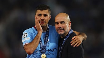 File image of Manchester City midfielder Rodri and manager Pep Guardiola. Reuters