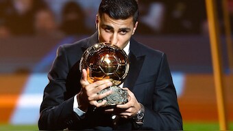 Spanish midfielder Rodri kisses the Ballon d'Or trophy at the ceremony in Paris. Reuters 
