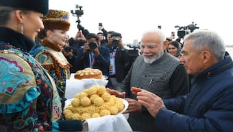 Indian Prime Minister Narendra Modi, second right, tries Tatar traditional sweet Chak-chak upon his arrival at Kazan International Airport for the BRICS Summit in Kazan, Russia, Tuesday, October 22, 2024. AP