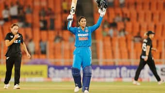 India opener Smriti Mandhana raises her bat in celebration after completing her century during the third ODI against New Zealand in Ahmedabad. PTI