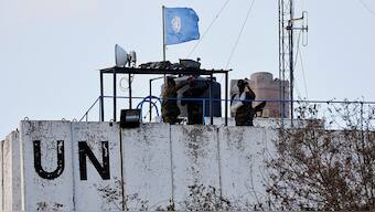 (File) Members of the United Nations peacekeepers (UNIFIL) look at the Lebanese-Israeli border, as they stand on the roof of a watch tower ‏in the town of Marwahin, in southern Lebanon, on October 12, 2023. Reuters