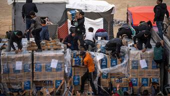 Palestinians grab humanitarian aid from a truck as it crossed into the Gaza Strip in Rafah, December 17, 2023. File Image/AP