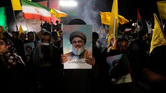 A cleric holds a poster of slain Hezbollah chief Hassan Nasrallah during an anti-Israeli gathering celebrating Iran's missile strike against Israel at Palestine Square in Tehran, Iran, on October 1, 2024. (Photo: AP)