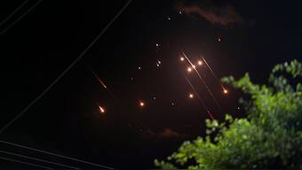 Missiles launched from Iran towards Israel streak across the night sky as seen from Deir al-Balah, Gaza Strip, October 1, 2024. AP