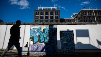 A man walks along a stretch of the Berlin wall (1961-1989) at the East-side Gallery in Berlin on September 30, 2024. Germany will mark 35 years since the fall of the Berlin Wall on November 9, 2024. AFP