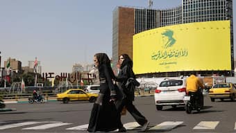 People walk past a billboard with a picture of the late Lebanon's Hezbollah leader Hassan Nasrallah, in a street in Tehran, Iran, October 2, 2024. Reuters 