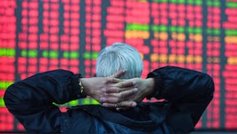An investor looks at a screen showing stock market movements at a securities company in Hangzhou, in eastern China's Zhejiang province. AFP