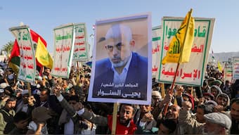A person holds a sign showing the late Hamas leader Yahya Sinwar as protesters, mainly Houthi supporters, rally to show support to Lebanon's Hezbollah and Palestinians in the Gaza Strip, in Sanaa, Yemen October 18, 2024. Reuters