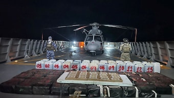 Members of the Mexican Navy stand guard next to packages on display after seizing some 8.4 thousand kilograms of illicit cargo. Reuters