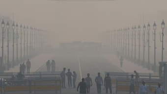 People walk on Kartavya Path amidst the morning smog in New Delhi, India, October 23, 2024. REUTERS