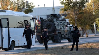 Turkish police officers gather as an armed personnel vehicle drives along a road in Kahramankazan. AFP