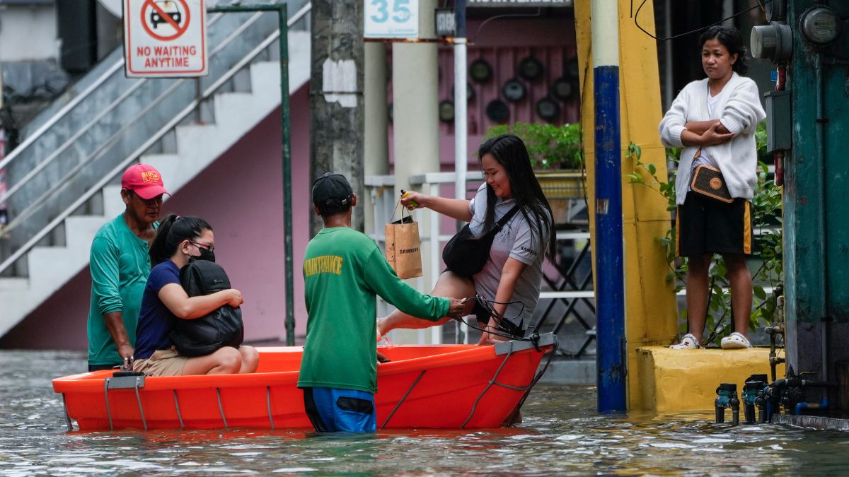 Residents use a boat to cross flooded streets caused by Tropical Storm Trami on Friday, Oct. 25, 2024, in Cainta, Rizal province, Philippines. AP Residents use a boat to cross flooded streets caused by Tropical Storm Trami on Friday, Oct. 25, 2024, in Cainta, Rizal province, Philippines. AP