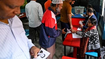 People check their names in the electoral rolls to cast their votes at a polling station during Bangladesh's general elections in Dhaka on January 7, 2024. AFP file/Representational image