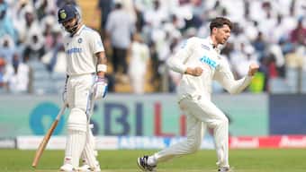 New Zealand left-arm spinner Mitchell Santner celebrates after dismissing India's Virat Kohli on Day 3 of the second Test in Pune. AP