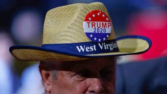 A supporter wears a campaign button on his hat as he waits for former president Donald Trump to speak at a rally at WesBanco Arena on September. 29, 2018, in Wheeling, West Virginia. AP