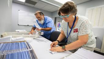 Dawn Stephens, right, and Duane Taylor prepare ballots to be mailed at the Mecklenburg County Board of Elections in Charlotte, N.C., Sept. 5, 2024. (Photo: AP)