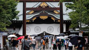 (File) People carry umbrellas as they visit Yasukuni Shrine in Tokyo, Japan. Reuters