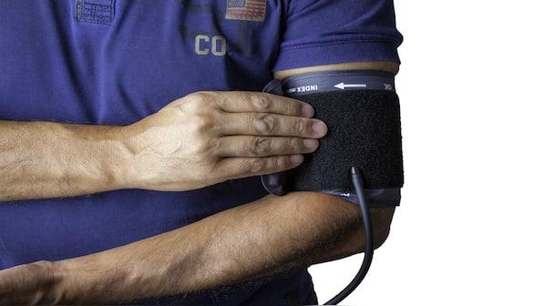 How should you place your arm during a blood pressure reading?