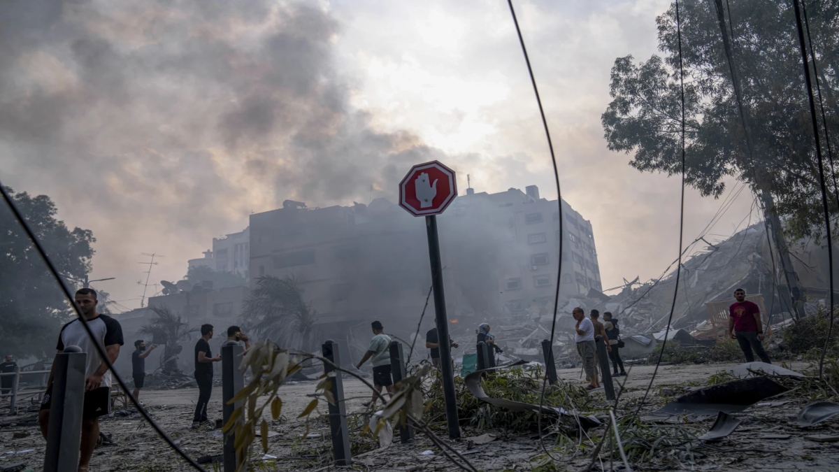 Palestinians walk by the rubble of a building after it was struck by an Israeli airstrike, in Gaza City, Sunday, Oct. 8, 2023. File Image / AP Palestinians walk by the rubble of a building after it was struck by an Israeli airstrike, in Gaza City, Sunday, Oct. 8, 2023. File Image / AP