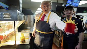  Republican presidential nominee former President Donald Trump, left, hands off an order of fries after working alongside an employee during a visit to McDonald’s in Feasterville-Trevose, Pa., Sunday, Oct. 20, 2024. AP