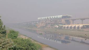 Smog engulfs the Jharoda Majra Metro Station station near Burari in New Delhi. PTI
