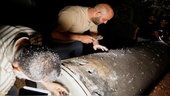 Palestinians investigate a projectile, after Iran fired a salvo of ballistic missiles, in Tubas, in the Israeli-occupied West Bank. Reuters