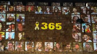 The walls of Jerusalem's Old city are projected with pictures of hostages kidnapped during the deadly October 7 attack on Israel by Hamas, a year after the deadly October 7 attack in Jerusalem. Reuters